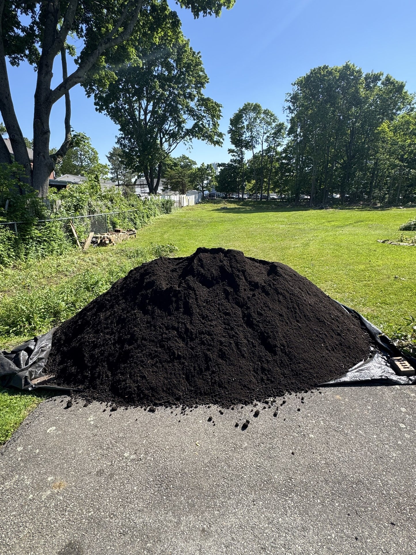 Four cubic yard pile of loam delivered to a residential driveway in Quincy, Massachusetts