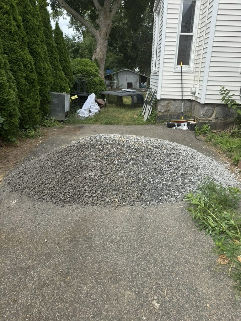 Crushed stone delivered for a gravel driveway repair in Massachusetts