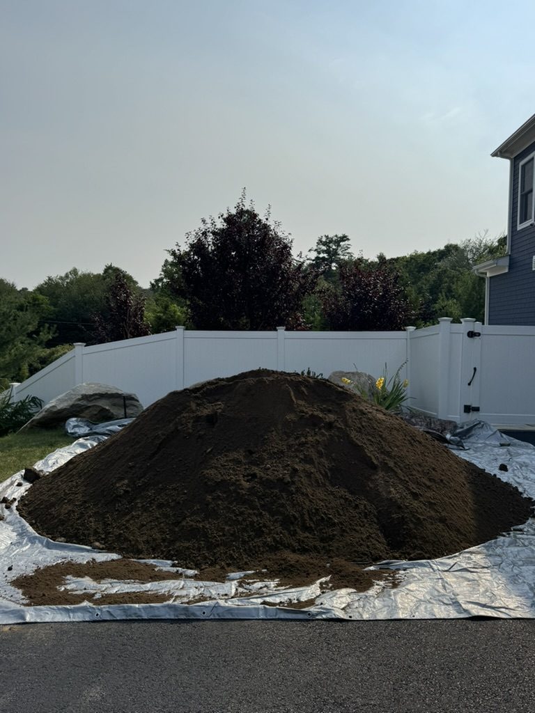 Screened loam pile on a tarp ready for lawn topdressing