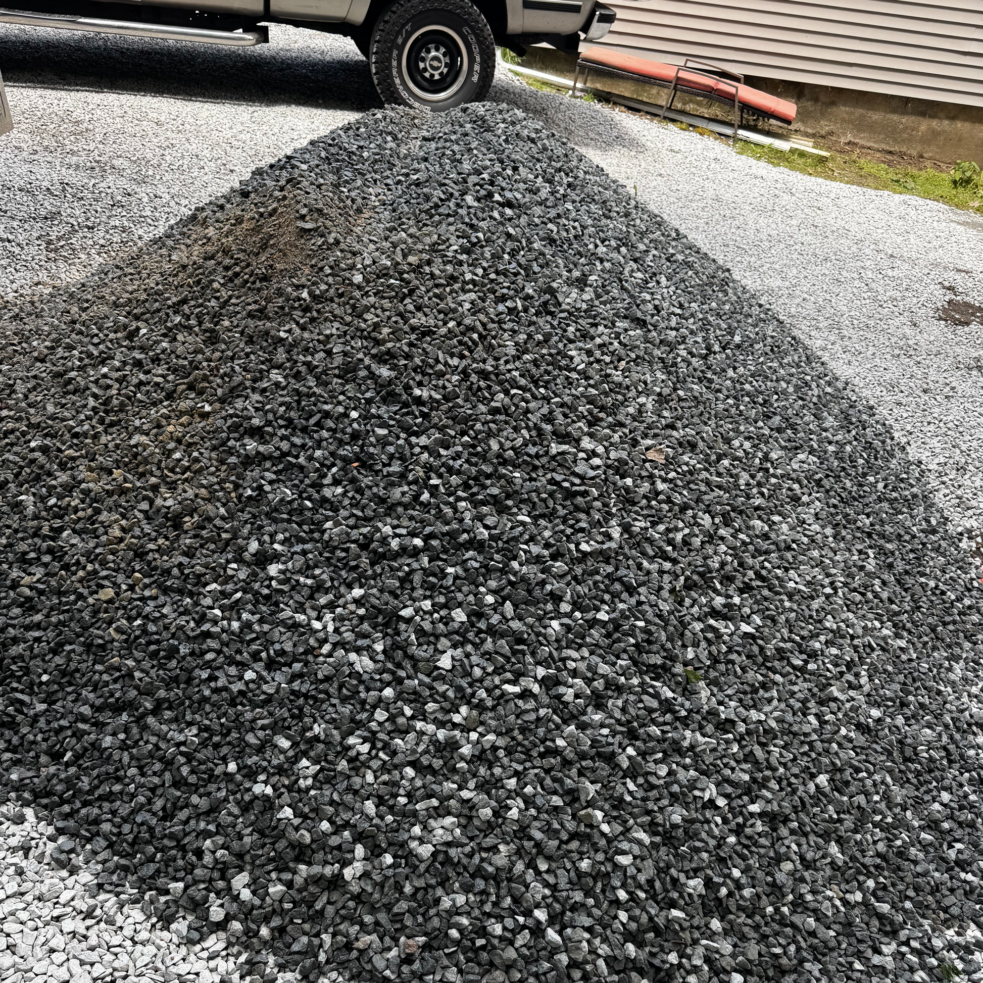 #57 crushed granite from above — angular faces, ¾-inch top size, native Boston-area gray granite