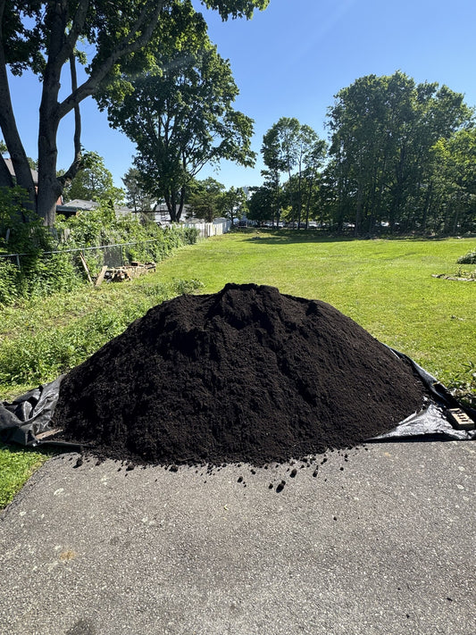 Four cubic yard pile of soil-fill material delivered to a residential driveway in Quincy, Massachusetts