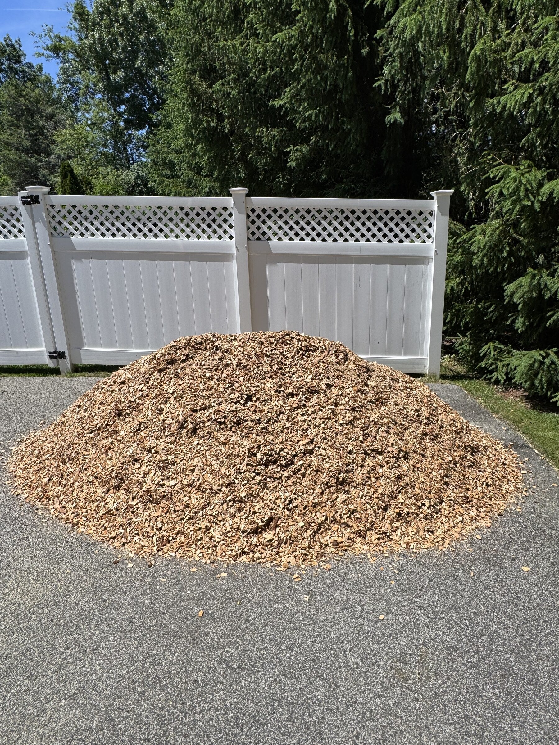 Cubic yard pile of playground mulch delivered to a residential driveway in Massachusetts