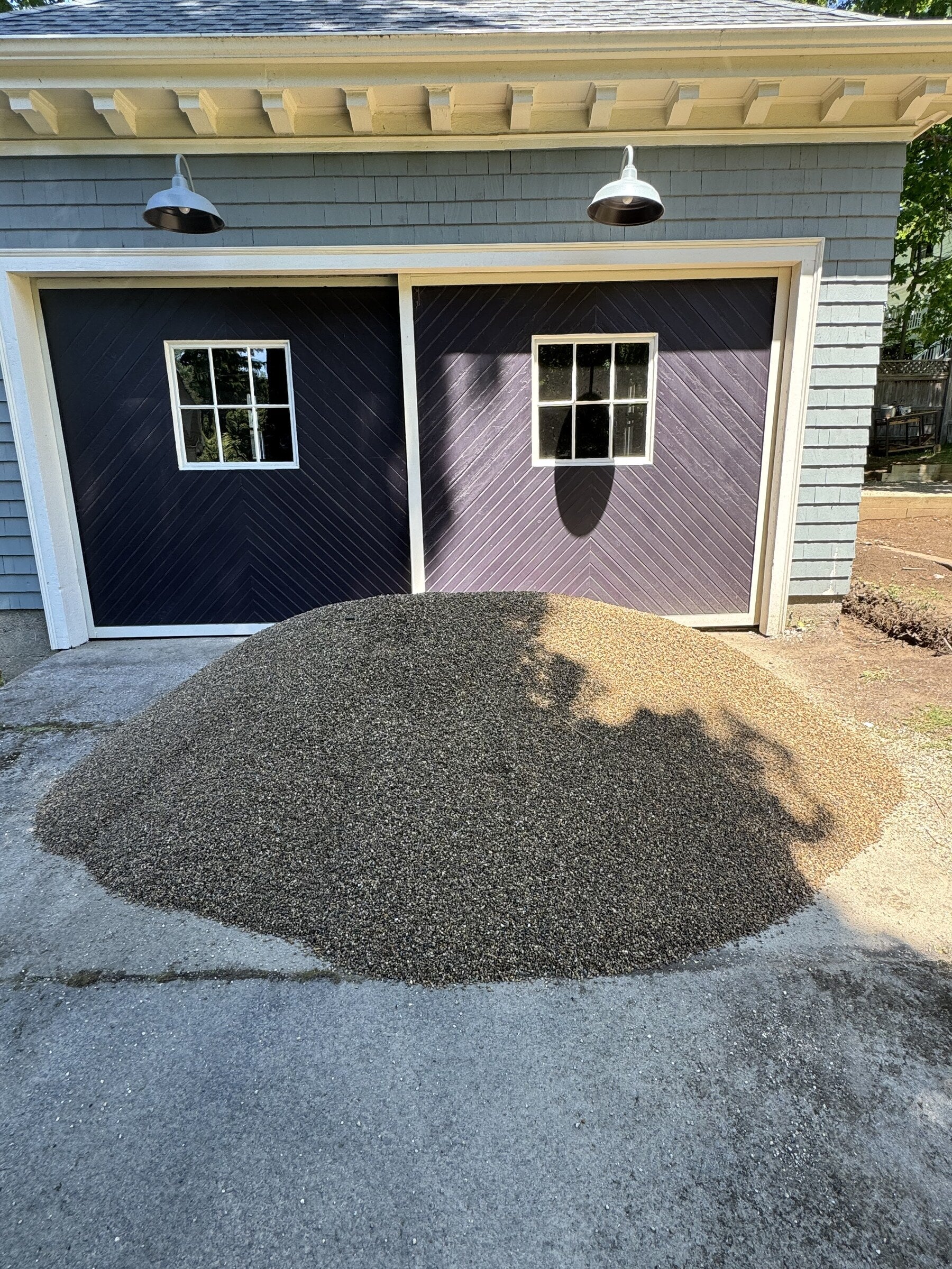 Three cubic yard pile of rice stone delivered to a residential driveway in Winchester, Massachusetts